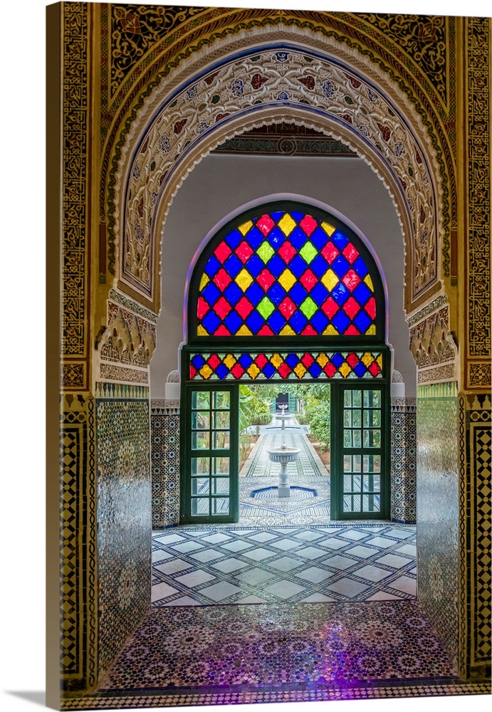 Morocco, Marrakech-Safi (Marrakesh-Tensift-El Haouz) region, Marrakesh. Interior archway with view to gardens at Bahia Pal...