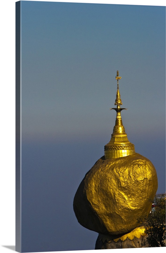 Myanmar, Burma, Golden Rock, Kyaiktiyo. The Golden Rock boulder balanced precariously on the edge of Mount Kyaiktiyo.