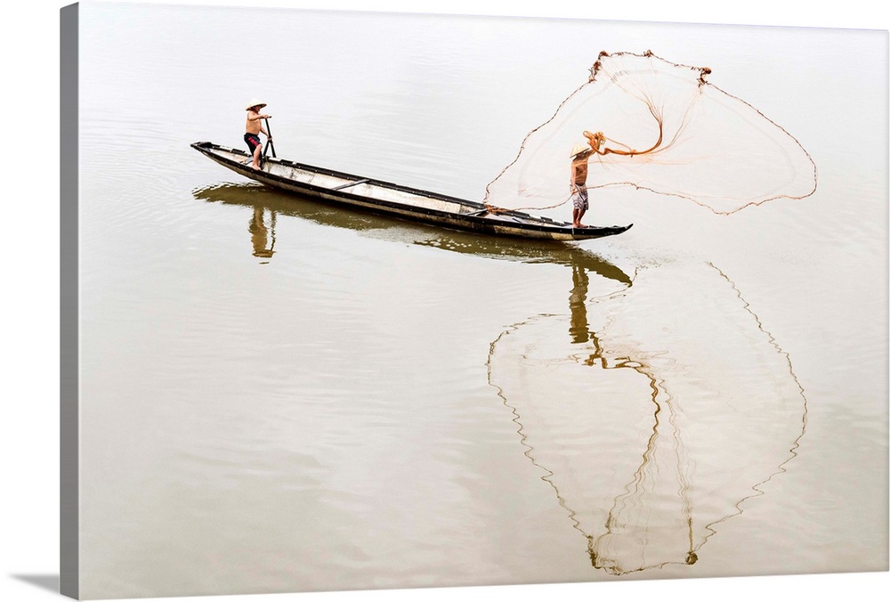 Net casting fishermen on the Perfume River, Hue, Vietnam.