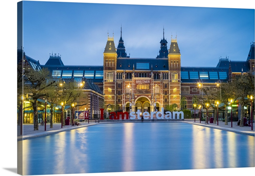 Netherlands, North Holland, Amsterdam. The Rijksmuseum on Museumplein at dusk.