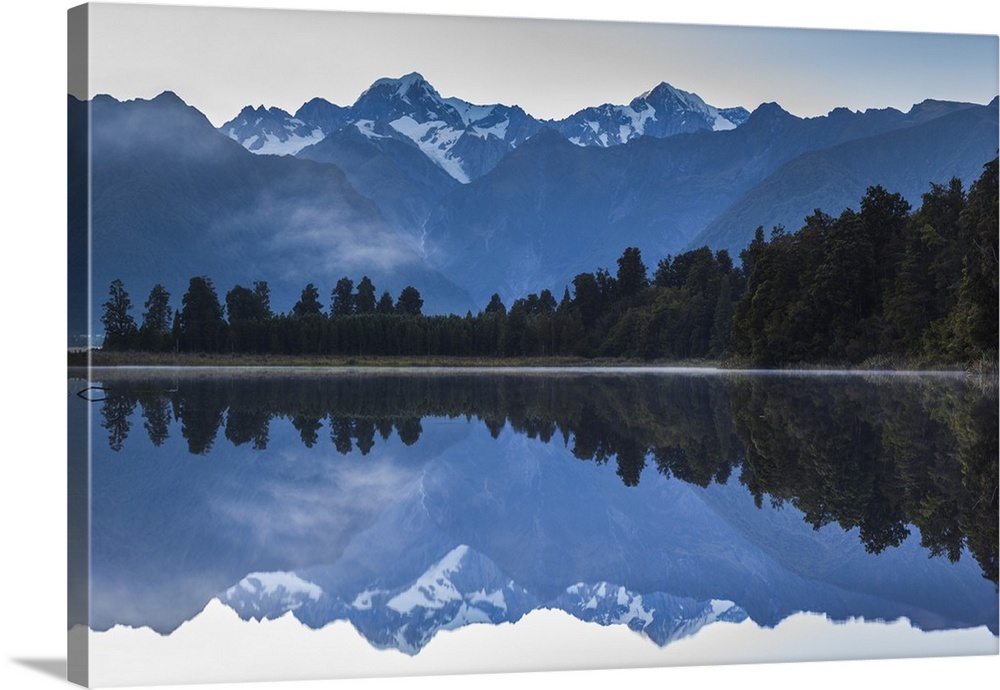 New Zealand, South Island, West Coast, Fox Glacier Village, Lake Matheson, reflection of Mt. Tasman and Mt. Cook, dawn.