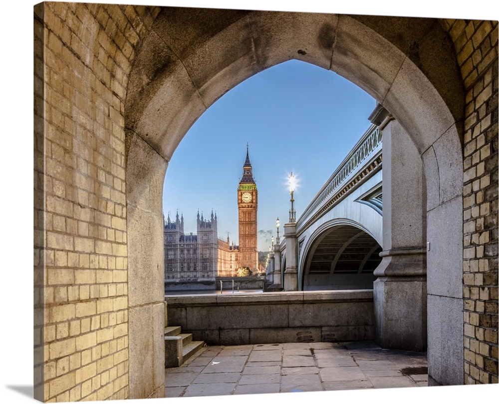 Night view of Big Ben and Westminster Palace from an old alley on the river bank, London, United Kingdom.