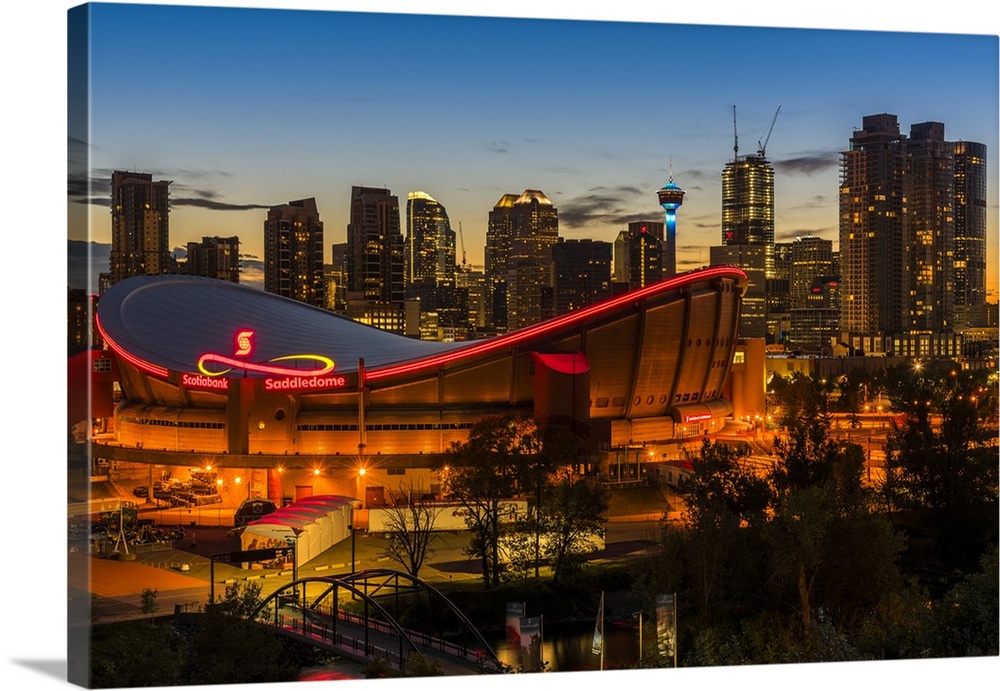 Night view of Saddledome stadium and city skyline, Calgary, Alberta, Canada.
