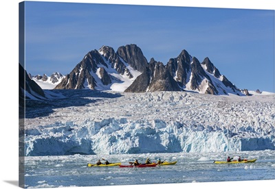Norway, kayaks paddle in brash ice past the magnificent Monaco Glacier