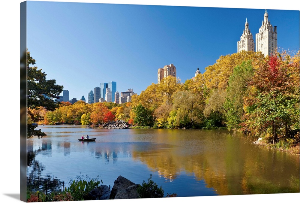 USA, New York City, Manhattan,  Central Park and the Grand buildings along Central Park West viewed across the lake in autumn