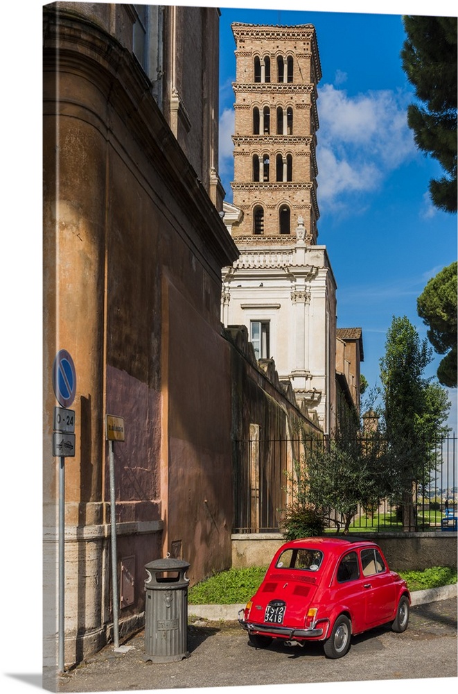 Old Fiat 500 car parked with Basilica dei Santi Bonifacio ed Alessio in the background, Rome, Lazio, Italy.