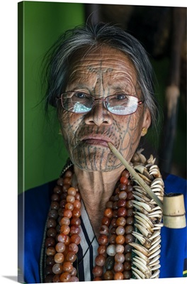Old Lady With Glasses And Traditional Facial Tattoo Smoking A Pipe, Mindat, Myanmar