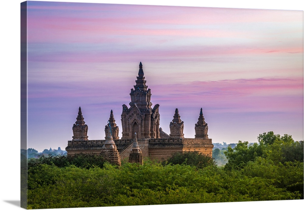 Old pagoda amidst trees against purple sky during sunrise, Bagan, Mandalay Region, Myanmar