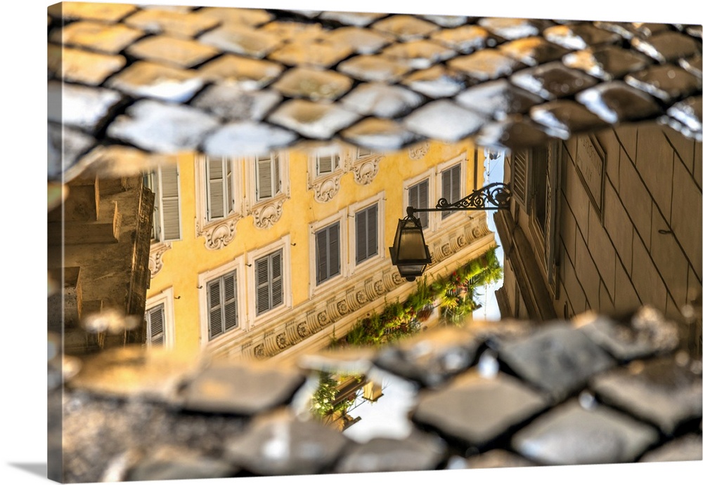 Picturesque corner of the old town reflected in a puddle on a cobbled street, Rome, Lazio, Italy