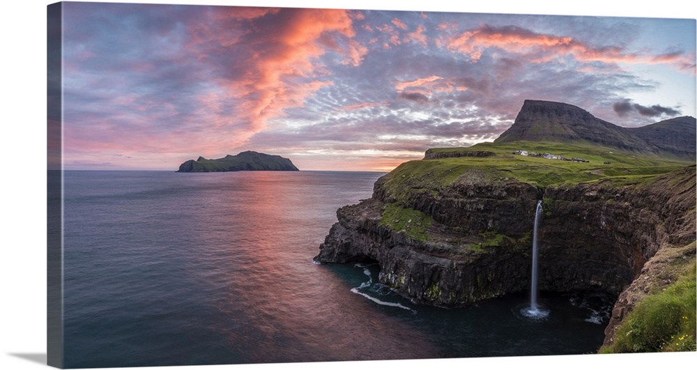 Gasadalur, Vagar island, Faroe Islands, Denmark. Panoramic view of Mykines and the iconic waterfall jumping from the cliff...
