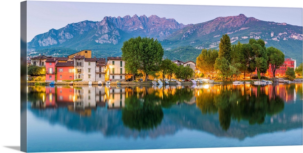 Lecco, Lombardy, Italy. Panoramic view of the colorful houses and the Mount Resegone reflected onto the river in Pescareni...