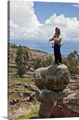 Peru, A Quechua-speaking man plays his flute on Taquile Island