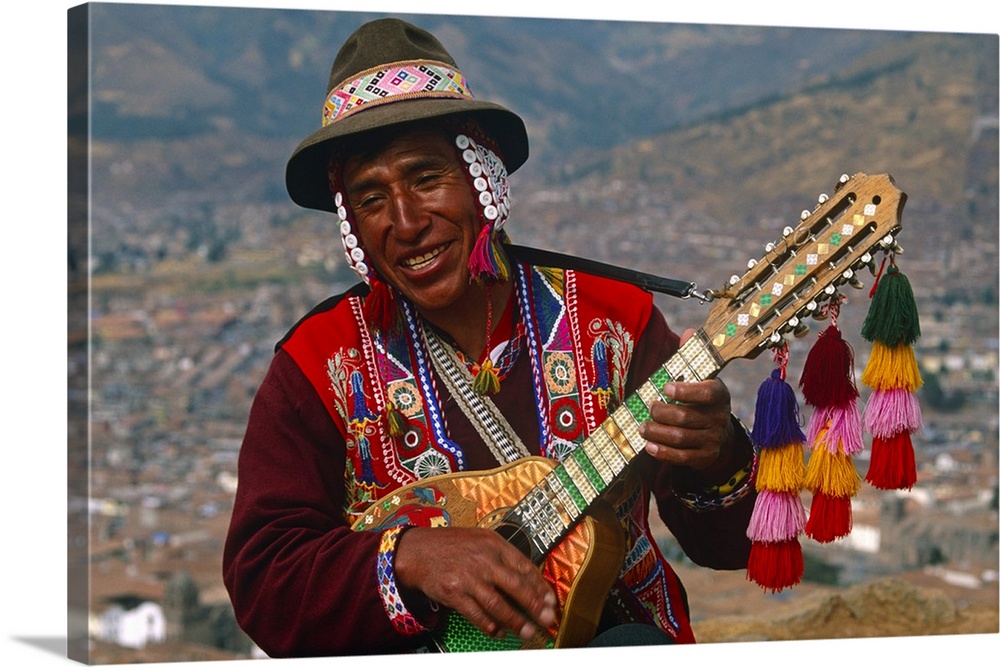 Peru, Cusco. An itinerant Quechuan musician plays his bandurria in the hills above Cusco.