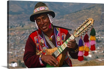 Peru, Cusco, An itinerant Quechuan musician plays his bandurria in the hills above Cusco