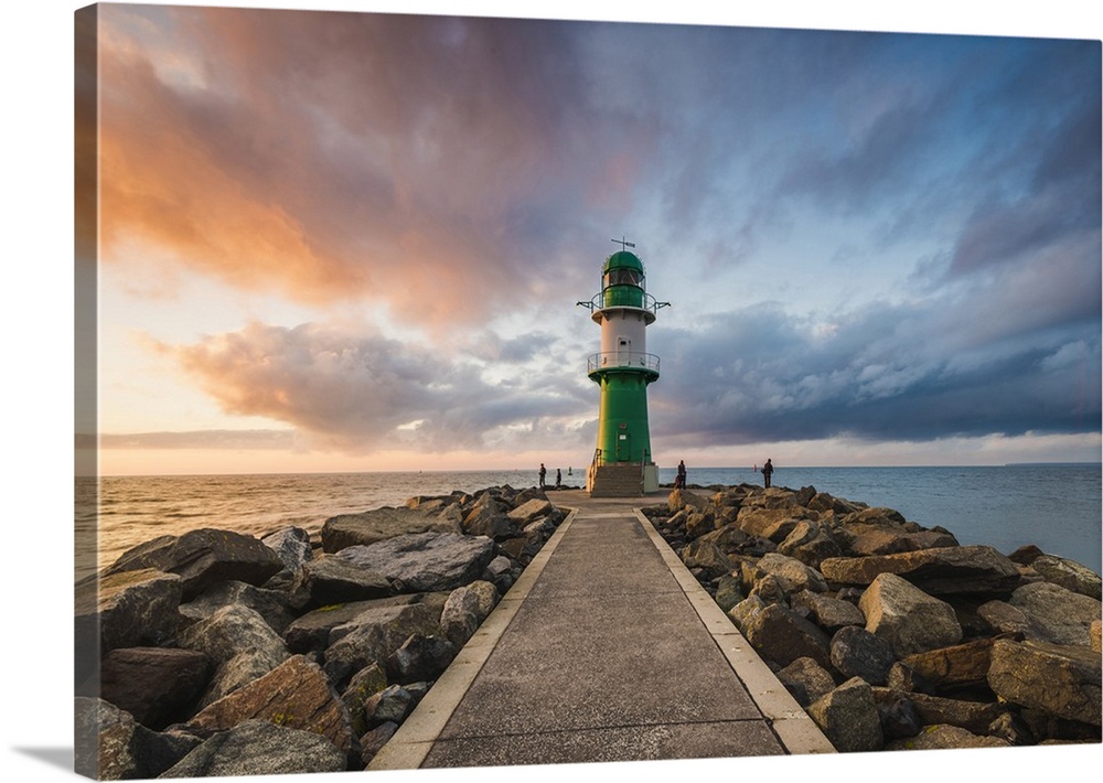 Warnermunde, Rostock district, Baltic coast, Mecklenburg-Western Pomerania, Germany. Pier to the lighthouse at sunset.