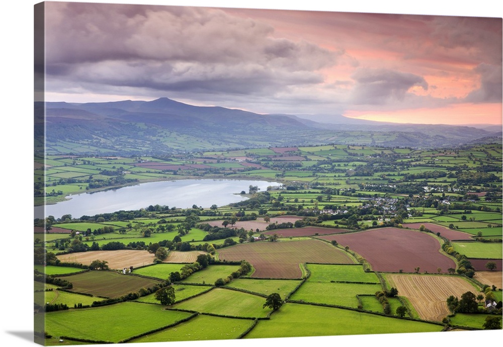 Pink sunset above the Brecon Beacons mountain range and rural countryside near Llangorse, Brecon Beacons National Park, Po...