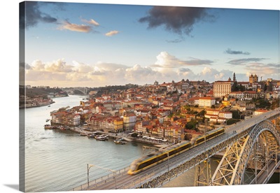 Porto at sunset with a train on Louis I bridge on Douro River