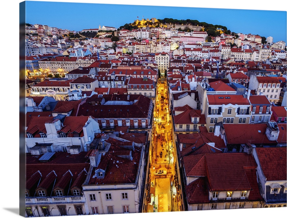 Portugal, Lisbon, Miradouro de Santa Justa, Twilight view over downtown and Santa Justa Street towards the castle hill.
