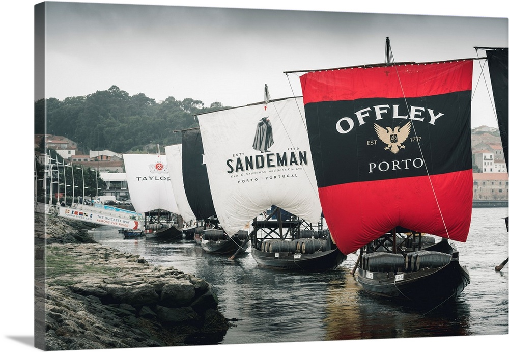 Portugal, Norte region, Porto (Oporto). Sailing boats showing porto wine brand names.