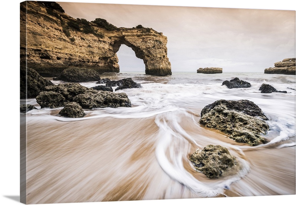 Praia de Albandeira, Lagoa, Algarve, Portugal. Waves between the rocks on the beach.