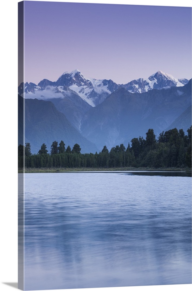 New Zealand, South Island, West Coast, Fox Glacier Village, Lake Matheson, reflection of Mt. Tasman and Mt. Cook, dusk.