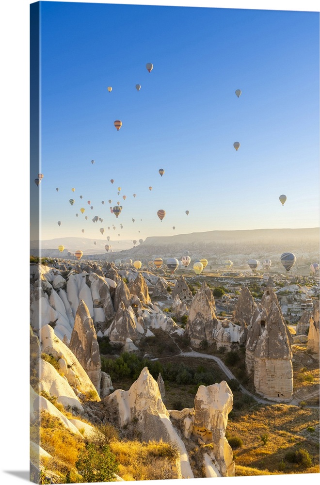 Rock formations, hot air balloons at sunrise, Goreme, Goreme Historical National Park, Nevsehir District, Nevsehir Provinc...