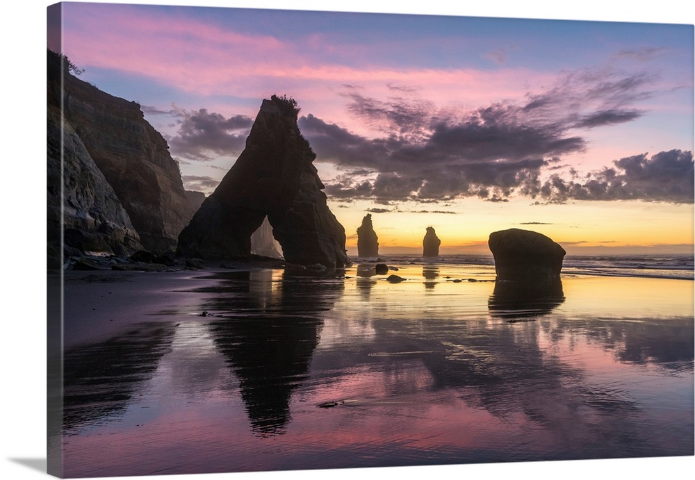 Rocks reflect with low tide at the Three Sisters beach, at sunset. Tongaporutu, New Plymouth district. Taranaki region, No...