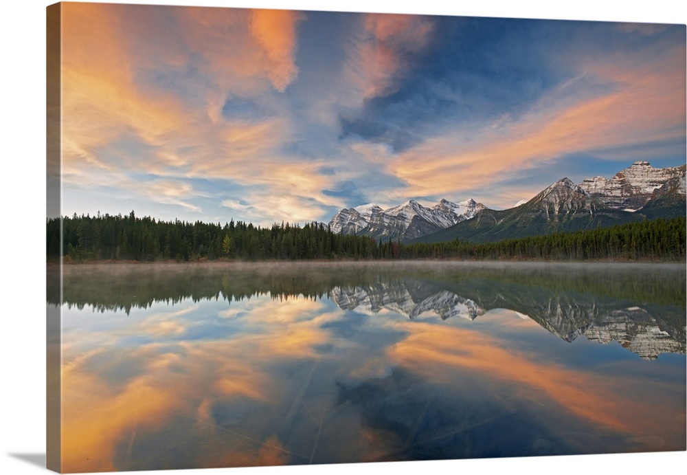Clouds and Rocky Mountains reflected in Herbert Lake, Banff National Park, Alberta, Canada