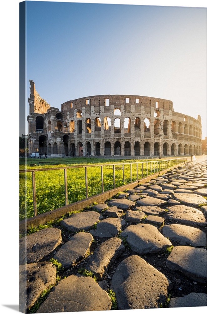 Rome, Lazio, Italy. Colosseum and Via Sacra (Sacred Road) at sunrise.