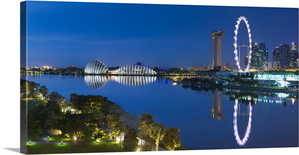 View of Singapore Flyer, Gardens by the Bay and Marina Bay Sands Hotel at dawn, Singapore.