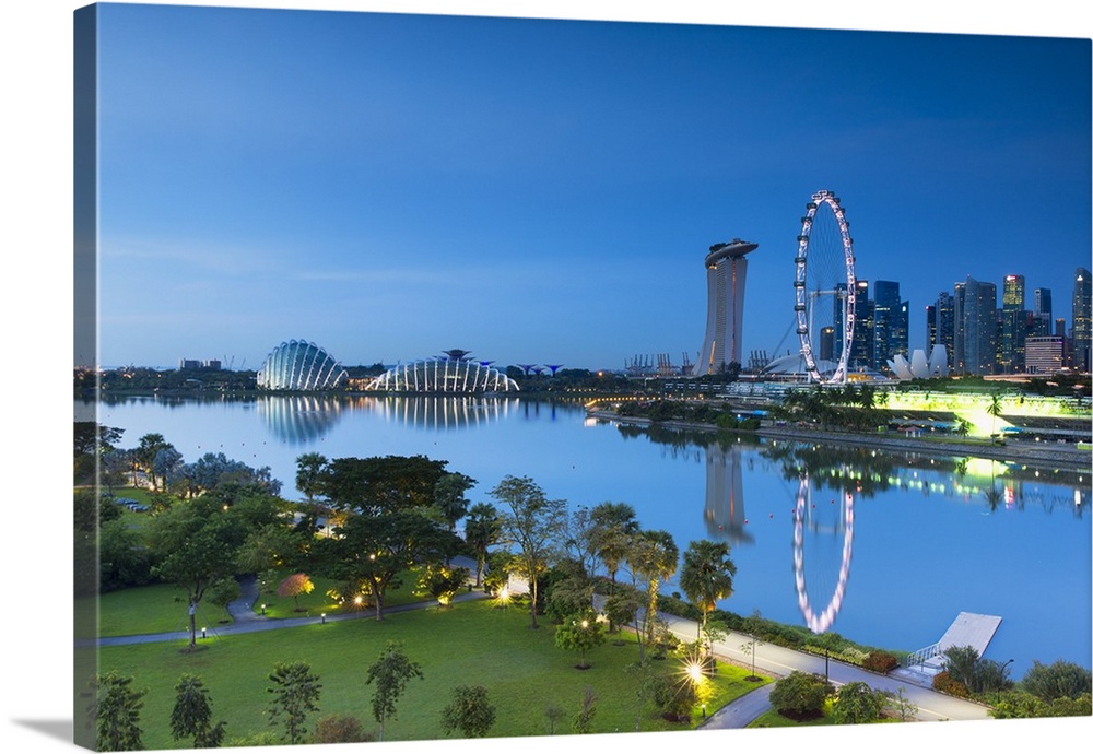 View of Singapore Flyer, Marina Bay Sands Hotel and Gardens by the Bay at dawn, Singapore.