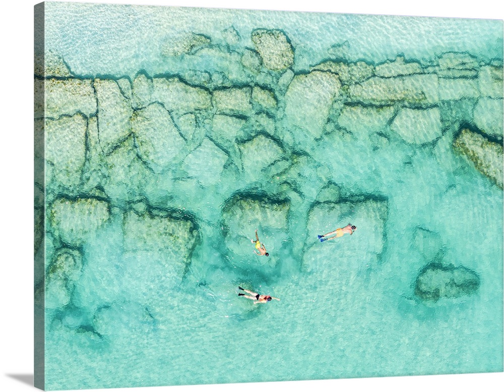 Overhead view of family with one boy enjoying snorkeling in the turquoise coloured sea, Antigua, Antigua & Barbuda, Caribbean