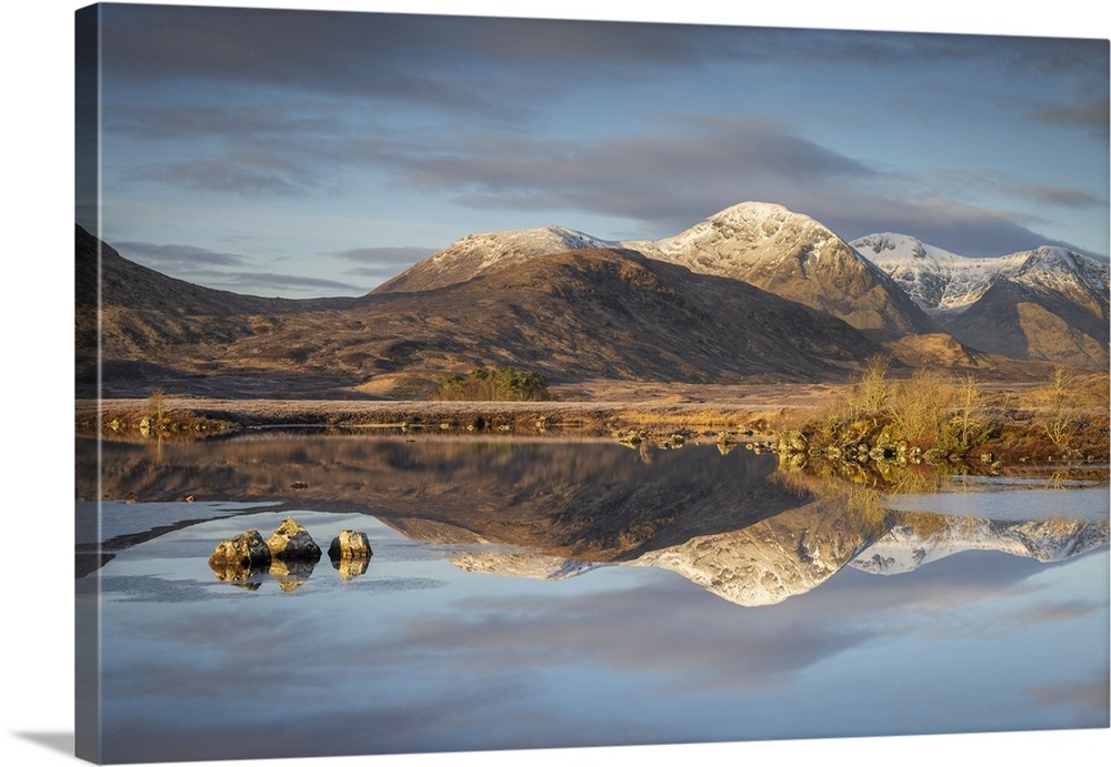 Snow capped mountain reflections in Lochan na h-Achlaise on a frosty winter morning in Rannoch Moor,  Scottish Highlands, ...