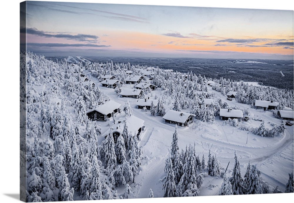 Snowy mountain huts in the frozen forest at sunset, Pudasjarvi, Iso Syote hill, Lapland, Finland