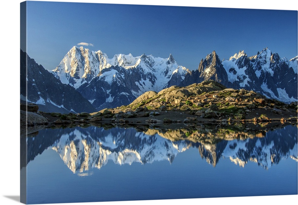Snowy peaks of Dent Du Geant and Grandes Jorasses are reflected in Lac Blanc, Haute Savoie, France, Europe.