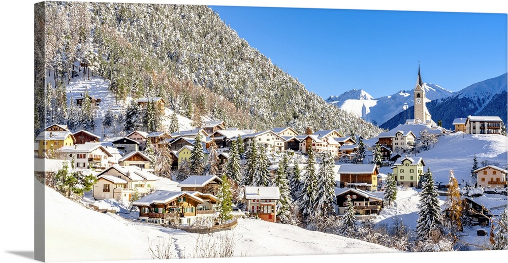 Snowy woods and mountains framing the alpine village of Alvaneu in winter, Davos, Graubunden canton, Switzerland