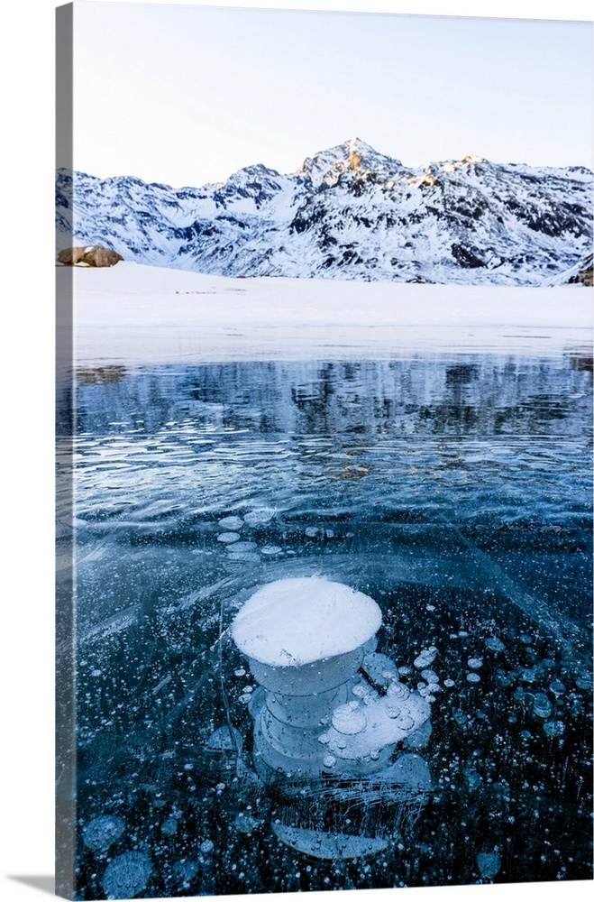 Stacks of methane bubbles trapped in the icy lake Montespluga, Madesimo, Valtellina, Lombardy, Italy