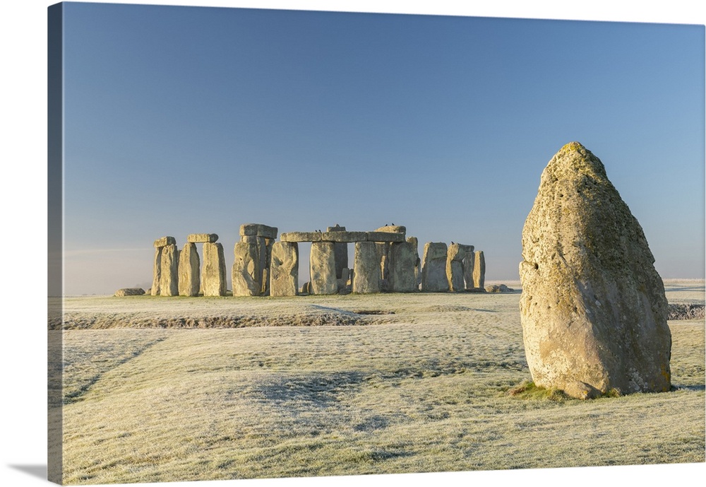 Stonehenge and the Heel Stone at dawn on a chill frosty winter morning, Wiltshire, England. Winter (January) 2022.