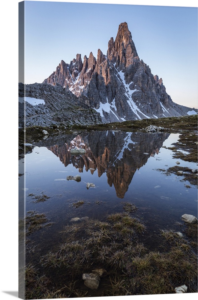 Sunrise on Mount Paterno reflected in a puddle, Natural Park Three Peaks, Sesto Pusteria, Bolzano district, South Tyrol, I...
