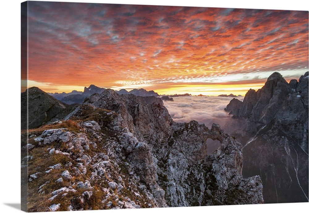 Colorful sunrise over the ridges of the Pale of the Balconies, Pala group, Dolomites, Italy. In the background mount Civet...