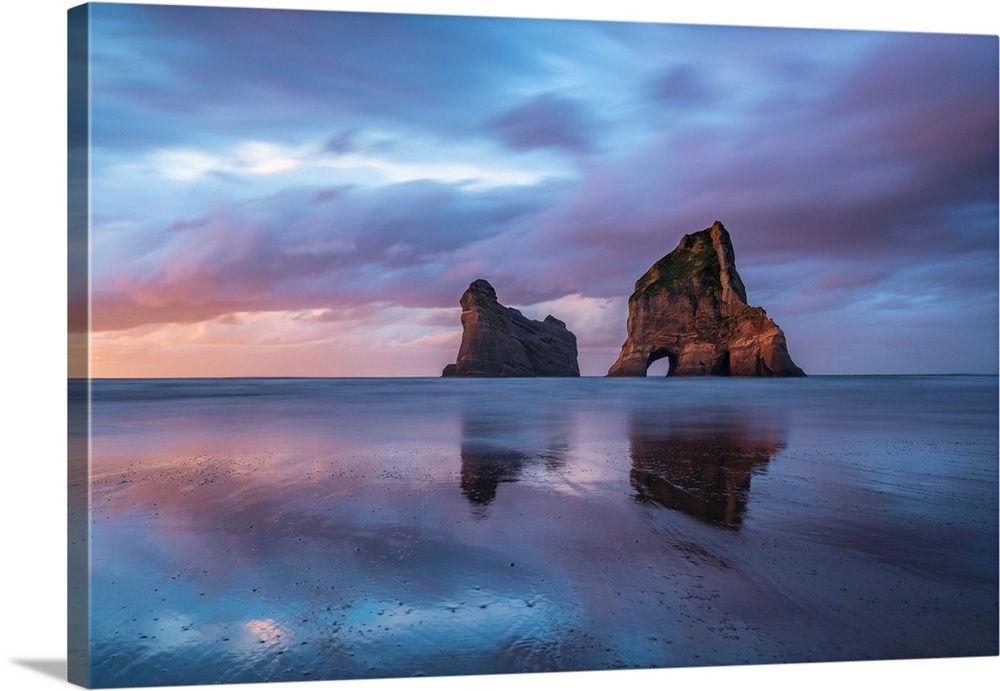 Sunset clouds above Archway Islands. Wharariki beach, Puponga, Tasman district, South Island, New Zealand.