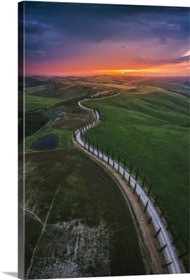 Sunset Over The Winding Road Of The Podere Baccoleno In The Crete Senesi, Tuscany, Italy