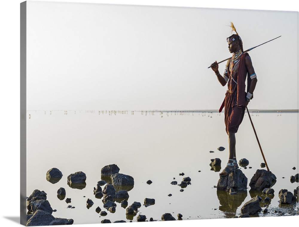Tanzania, Lake Natron, Shompole. A Maasai warrior looks out over Lake Natron.