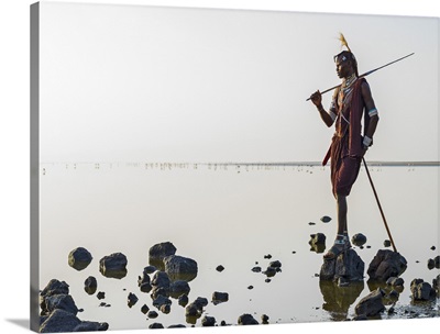 Tanzania, Lake Natron, Shompole, A Maasai warrior looks out over Lake Natron
