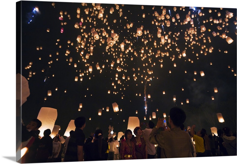 Thailand, Chiang Mai, San Sai. Revellers launch khom loi (sky lanterns) into the night sky during the Yi Peng festival. Th...