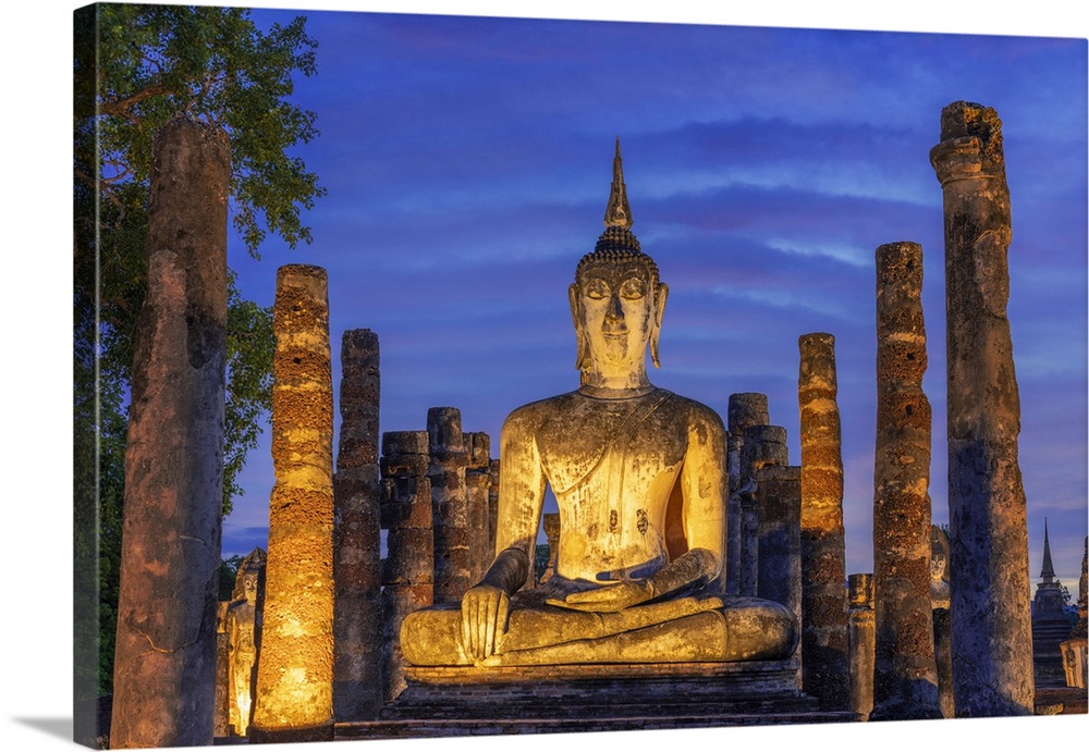 Thailand, Sukhothai province, Sukhothai,UNESCO World Heritage site, Wat Mahathat illuminated at dusk.