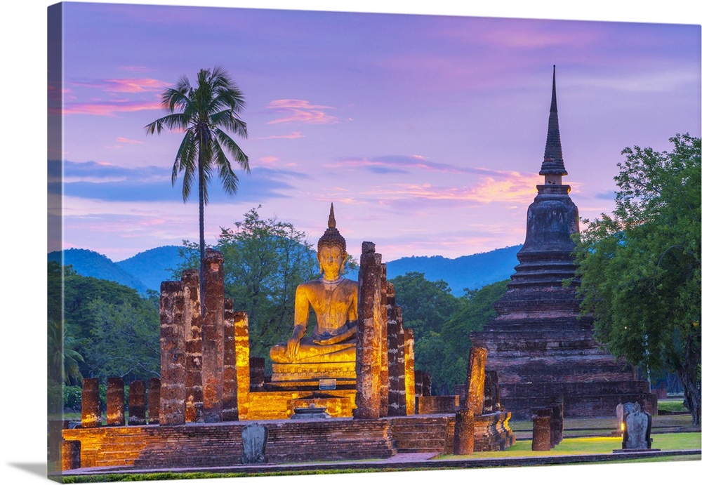 Thailand, Sukhothai province, Sukhothai, UNESCO World Heritage site, Wat Mahathat illuminated at dusk.