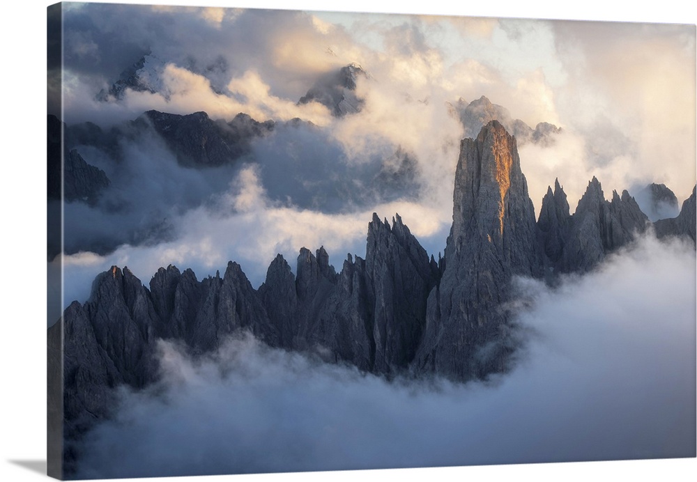 The Cadini di Misurina emerging from the sea of clouds during a stormy late summer sunset. Dolomites, Italy.