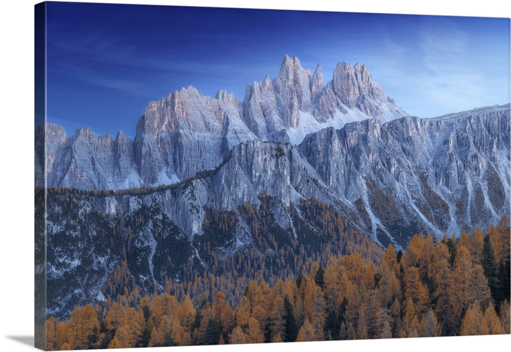 The Croda da Lago and Lastoi de Formin mountains at twilight, with the golden larches glowing in the darkness. Dolomites, ...