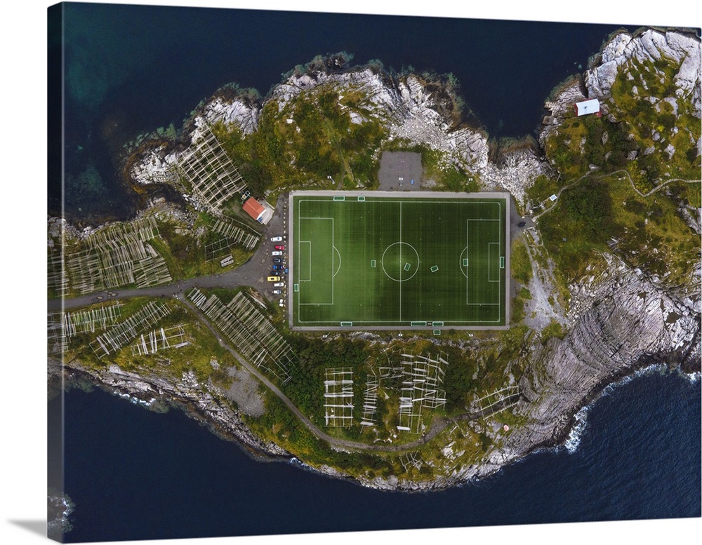 The football field of Henningsvaer framed by the rocks of the coast. Lofoten Islands, Norway.
